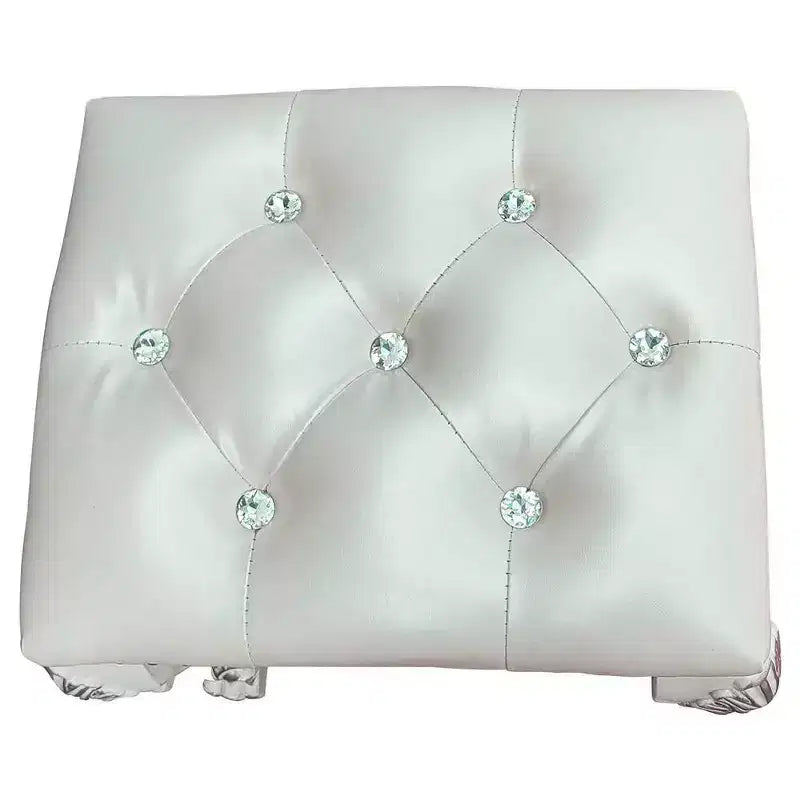 Un élégant fauteuil de salon au fini blanc, dégageant un esprit romantique ; des oreilles couleur champagne et des clous décoratifs.